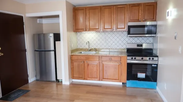a kitchen with stainless steel appliances a stove microwave and refrigerator
