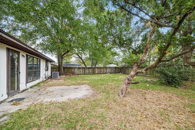 a view of backyard of house with green space