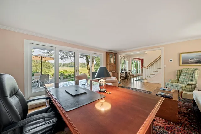 a bedroom with a bed and a dresser next to a window