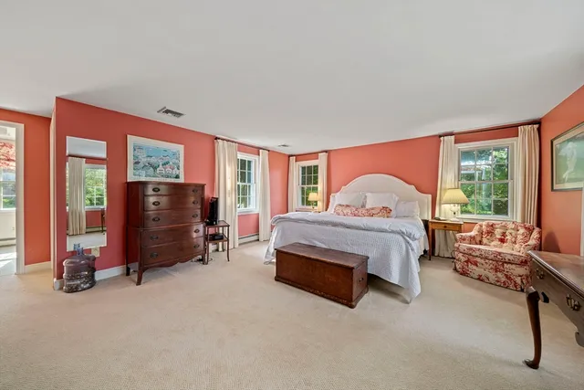 a bed room with a bed and a chair