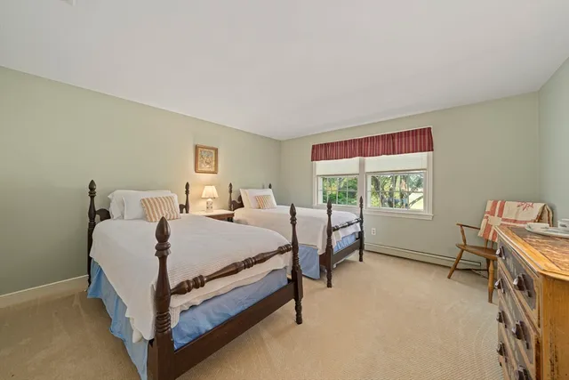 a bathroom with a toilet a sink and a mirror