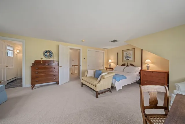 a view of a street with a yard and a large tree