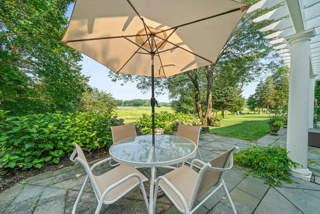 an aerial view of residential houses with outdoor space and trees