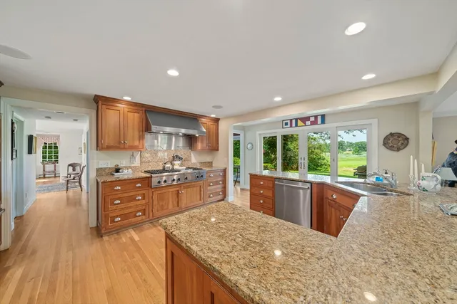 a kitchen with stainless steel appliances granite countertop a sink stove and refrigerator