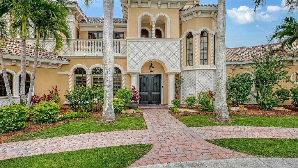 1630 Assisi Drive, Unit 18 Sarasota, FL 34231 - Photo 2 of 42 a front view of a house with a garden