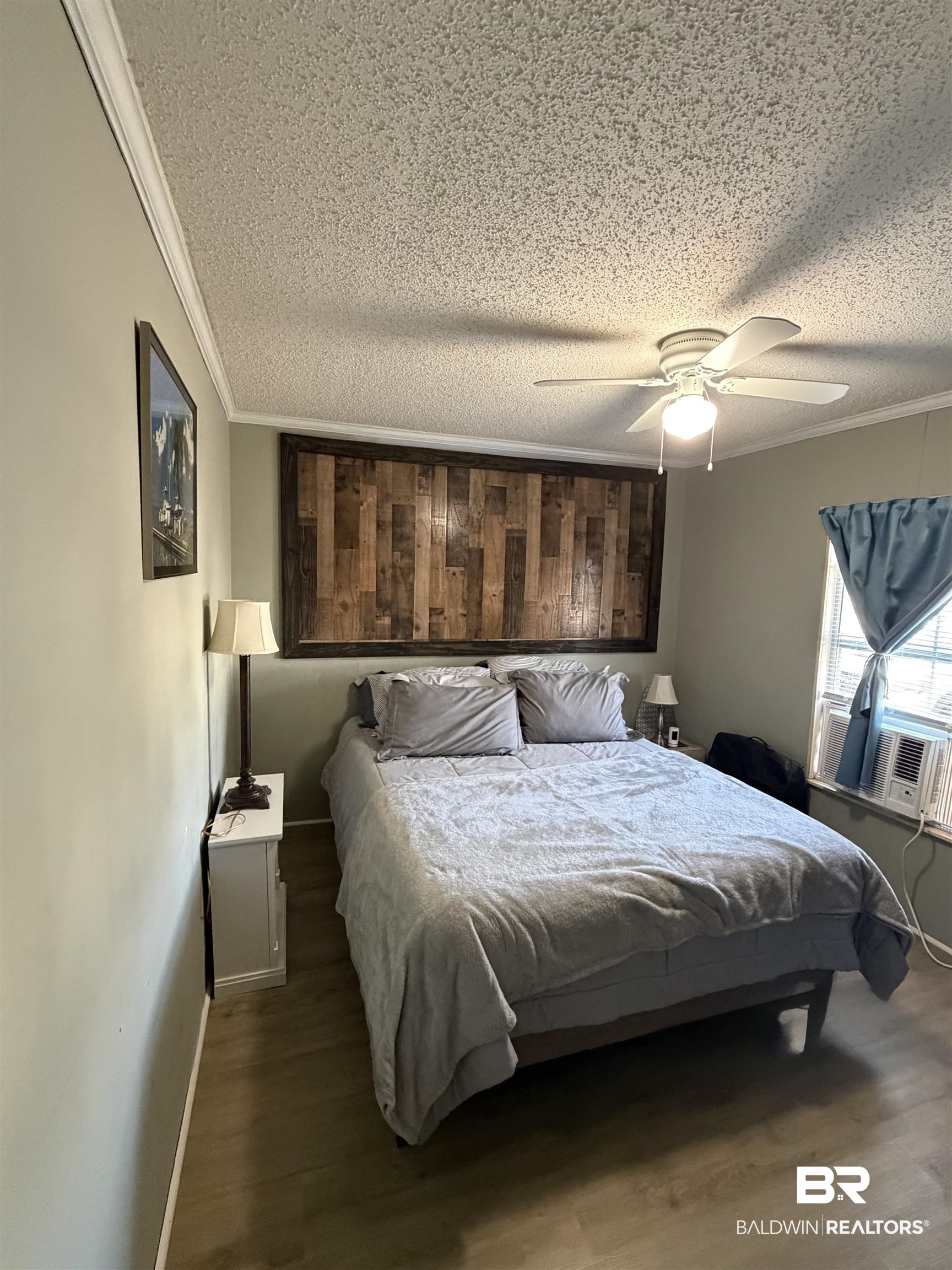 1913 Maria Lane Lillian, AL 36549 - Photo 7 of 35 Bedroom featuring wood finished floors, ceiling fan, crown molding, and a textured ceiling