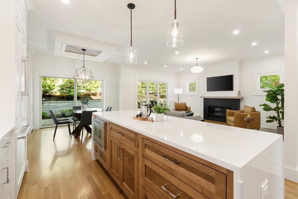 1124 Chestnut Street Newton, MA 02464 - Photo 11 of 41 a large kitchen with kitchen island a large island in the center