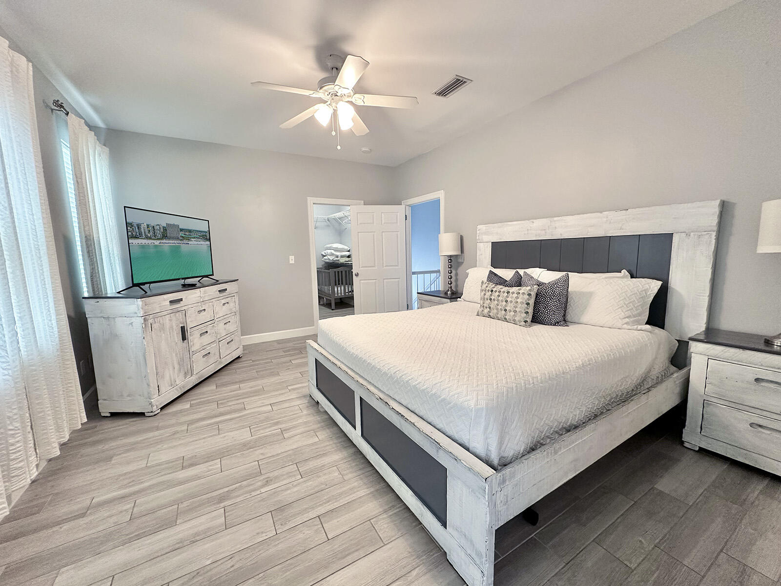83 Sunfish Street Destin, FL 32541 - Photo 36 of 56 a bedroom with a bed and a chandelier