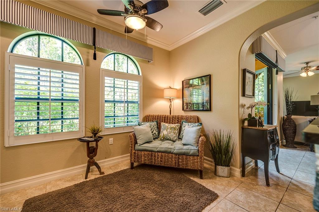 9161 Chula Vista Street, Unit 1352 Naples, FL 34113 - Photo 12 of 23 a living room with furniture and a large window
