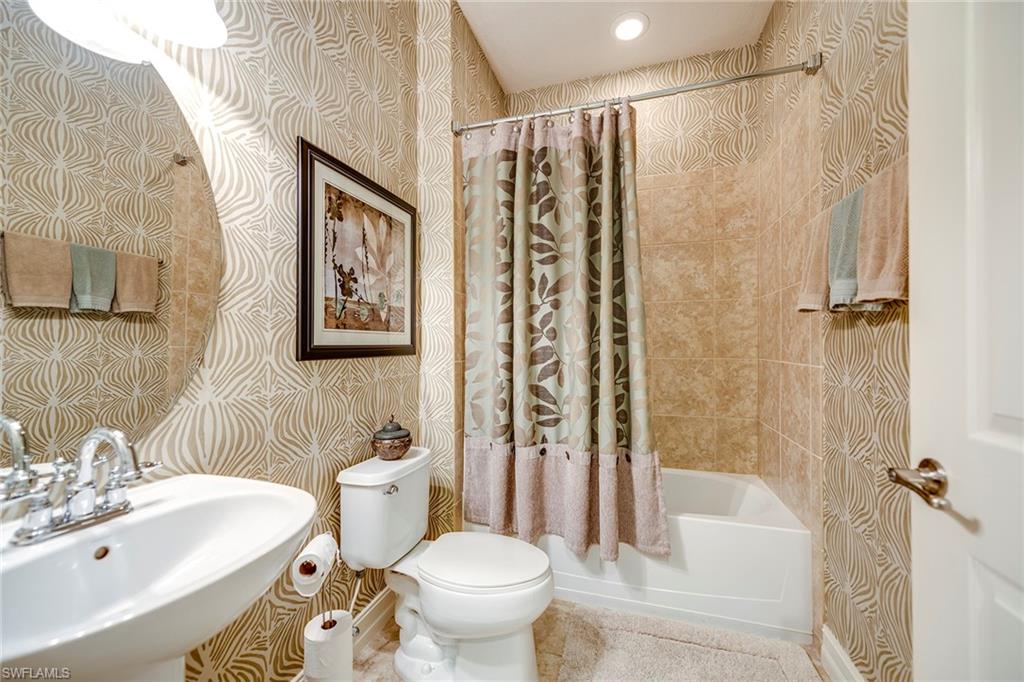 9161 Chula Vista Street, Unit 1352 Naples, FL 34113 - Photo 20 of 23 a bathroom with a sink toilet and shower