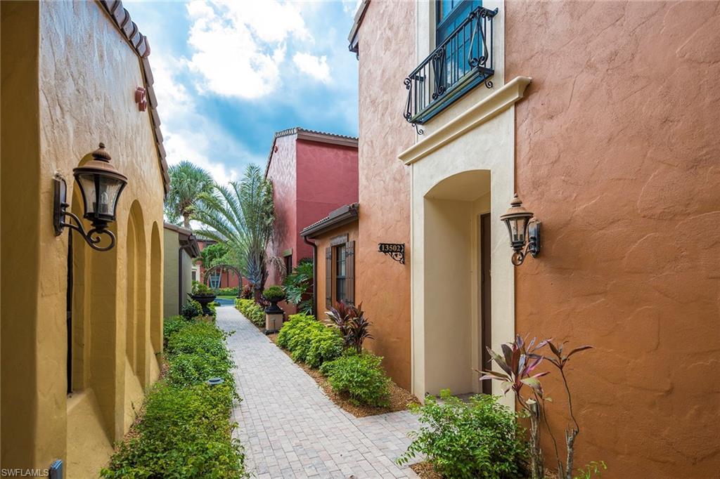 9161 Chula Vista Street, Unit 1352 Naples, FL 34113 - Photo 3 of 23 a front view of a house with a yard