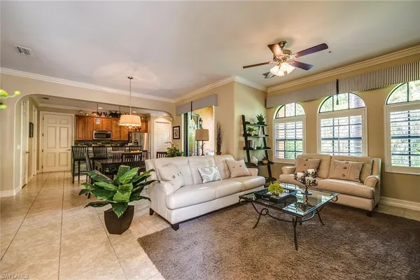 a living room with furniture potted plant and a chandelier