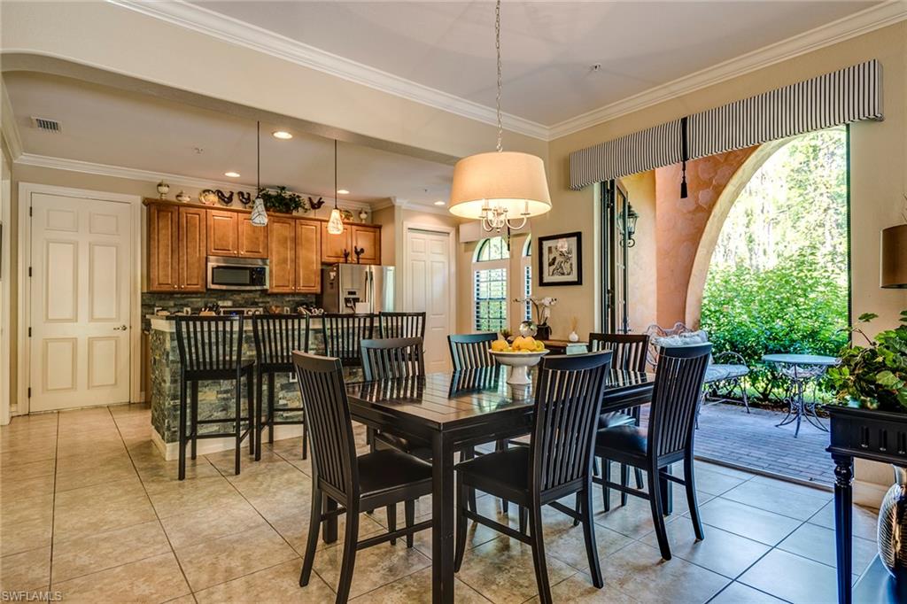9161 Chula Vista Street, Unit 1352 Naples, FL 34113 - Photo 7 of 23 a view of a dining room with furniture and window