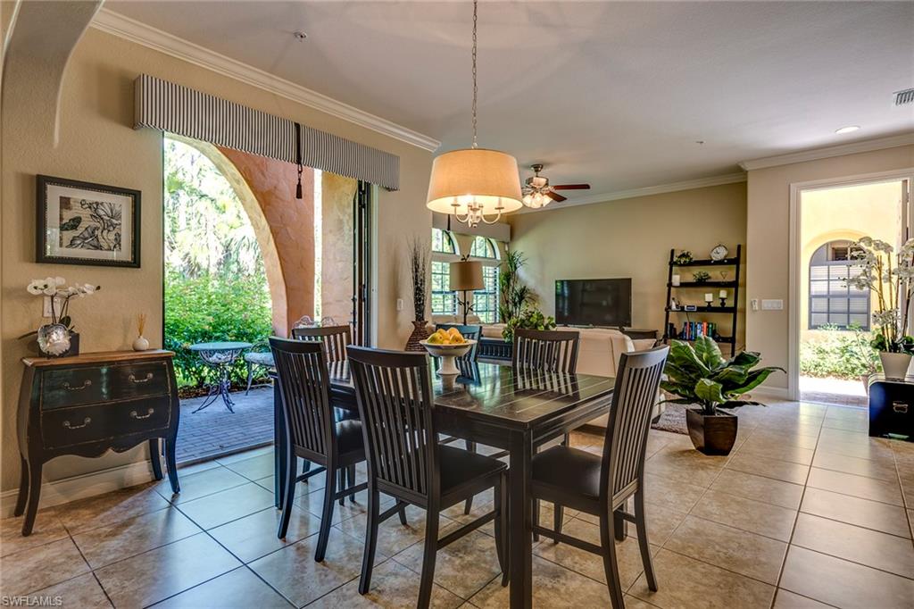 9161 Chula Vista Street, Unit 1352 Naples, FL 34113 - Photo 8 of 23 a view of a dining room with furniture window and outside view