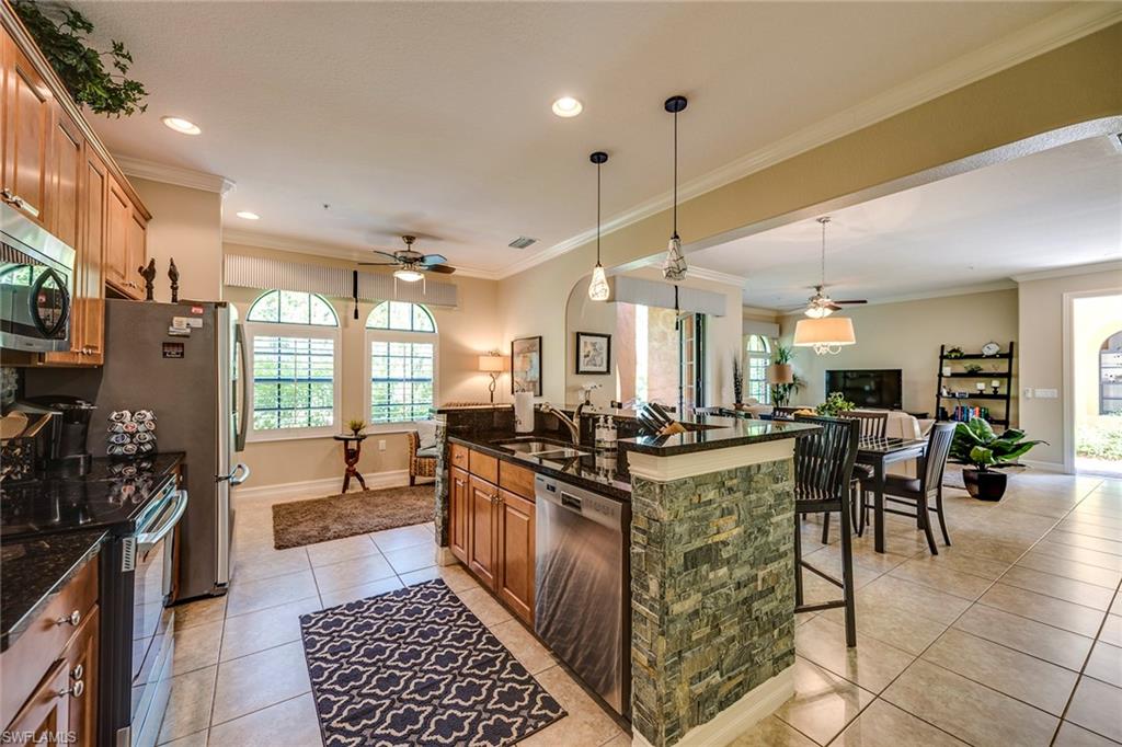 9161 Chula Vista Street, Unit 1352 Naples, FL 34113 - Photo 10 of 23 a kitchen with lots of counter top space