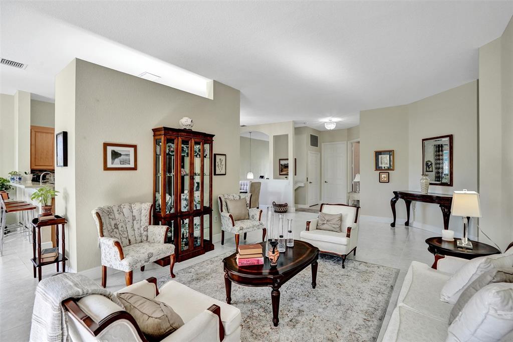 7967 Exeter Boulevard East, Unit 203 Tamarac, FL 33321 - Photo 13 of 42 a living room with furniture and floor to ceiling window