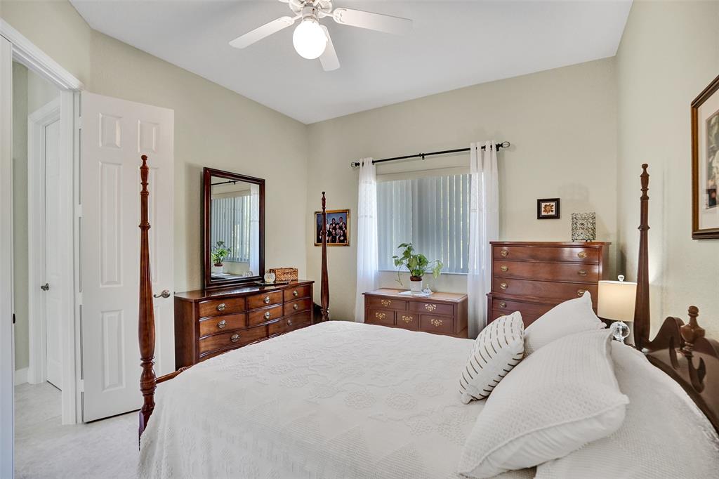 7967 Exeter Boulevard East, Unit 203 Tamarac, FL 33321 - Photo 20 of 42 a bedroom with a bed and a dresser