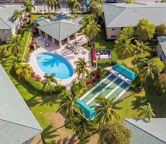 7967 Exeter Boulevard East, Unit 203 Tamarac, FL 33321 - Photo 26 of 42 an aerial view of a house with a swimming pool
