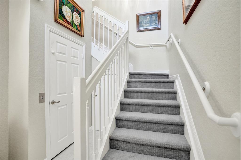7967 Exeter Boulevard East, Unit 203 Tamarac, FL 33321 - Photo 30 of 42 a view of staircase with lots of frames on wall and a window