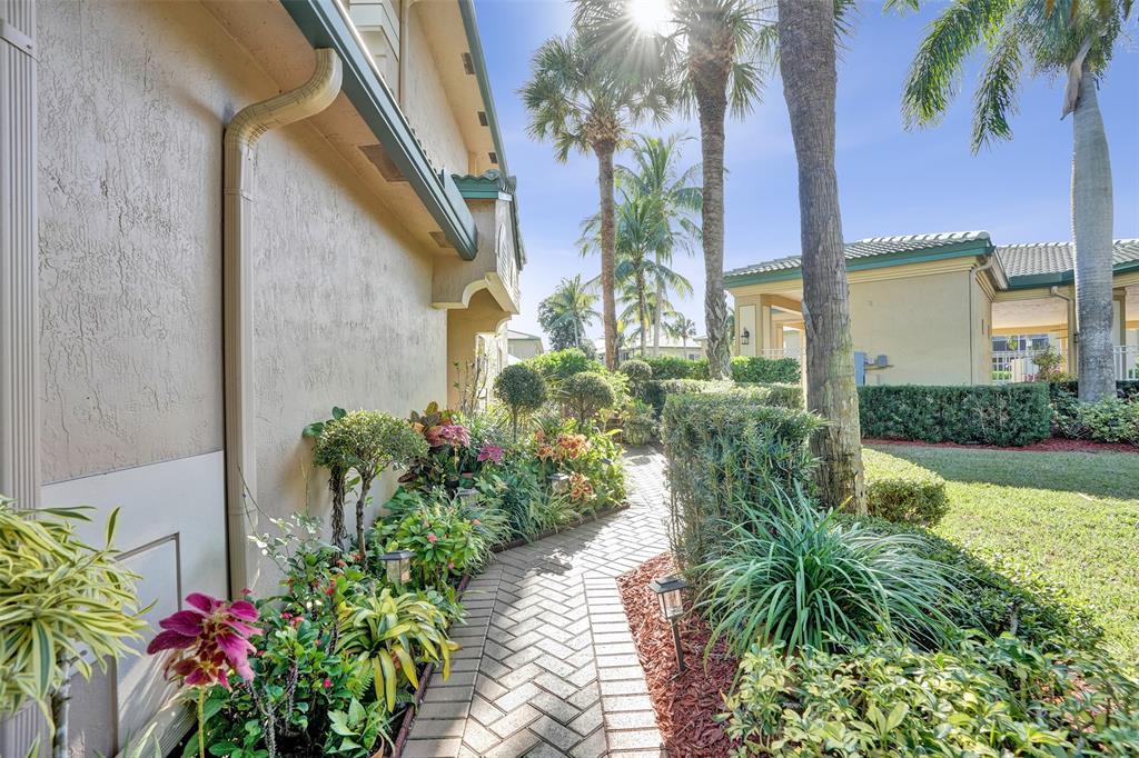 7967 Exeter Boulevard East, Unit 203 Tamarac, FL 33321 - Photo 31 of 42 *** AN INVITING WALKWAY TO THE FRONT DOOR ENTRY WITH BUTTERFLY GARDEN & PLANTS ***