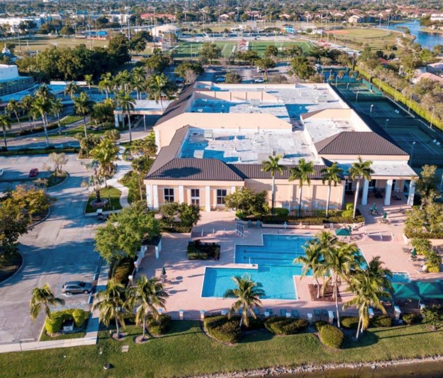 7967 Exeter Boulevard East, Unit 203 Tamarac, FL 33321 - Photo 38 of 42 an aerial view of a house with a garden and lake view