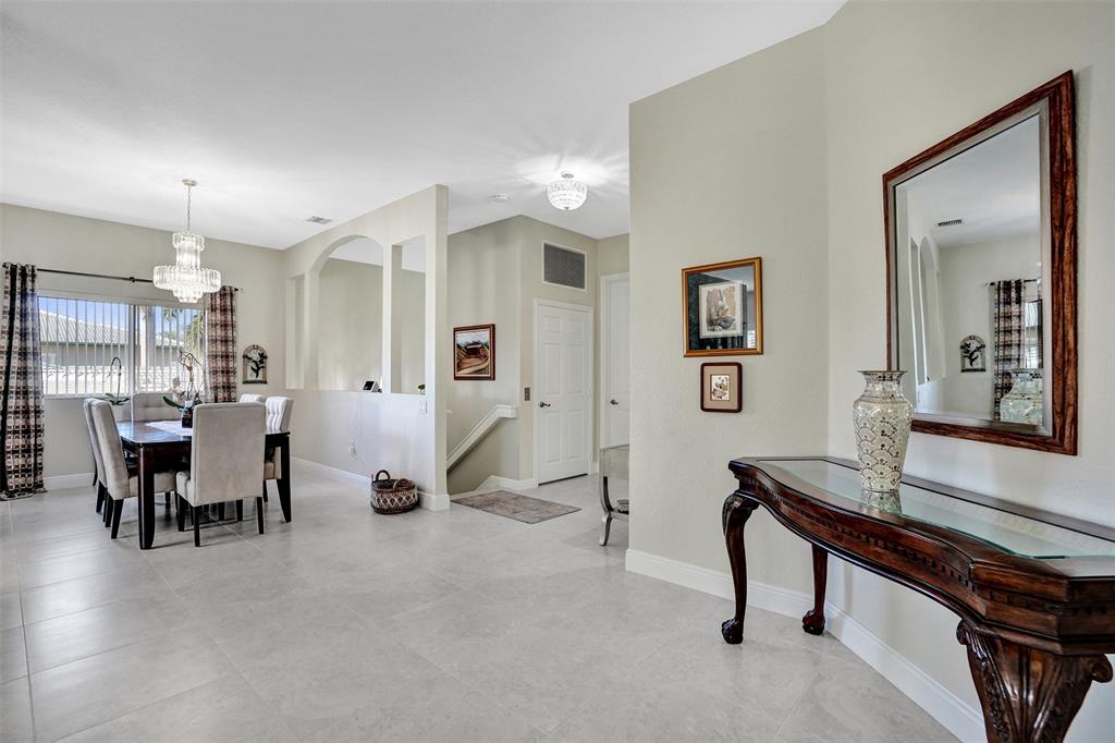 7967 Exeter Boulevard East, Unit 203 Tamarac, FL 33321 - Photo 10 of 42 a view of a livingroom with furniture and a table