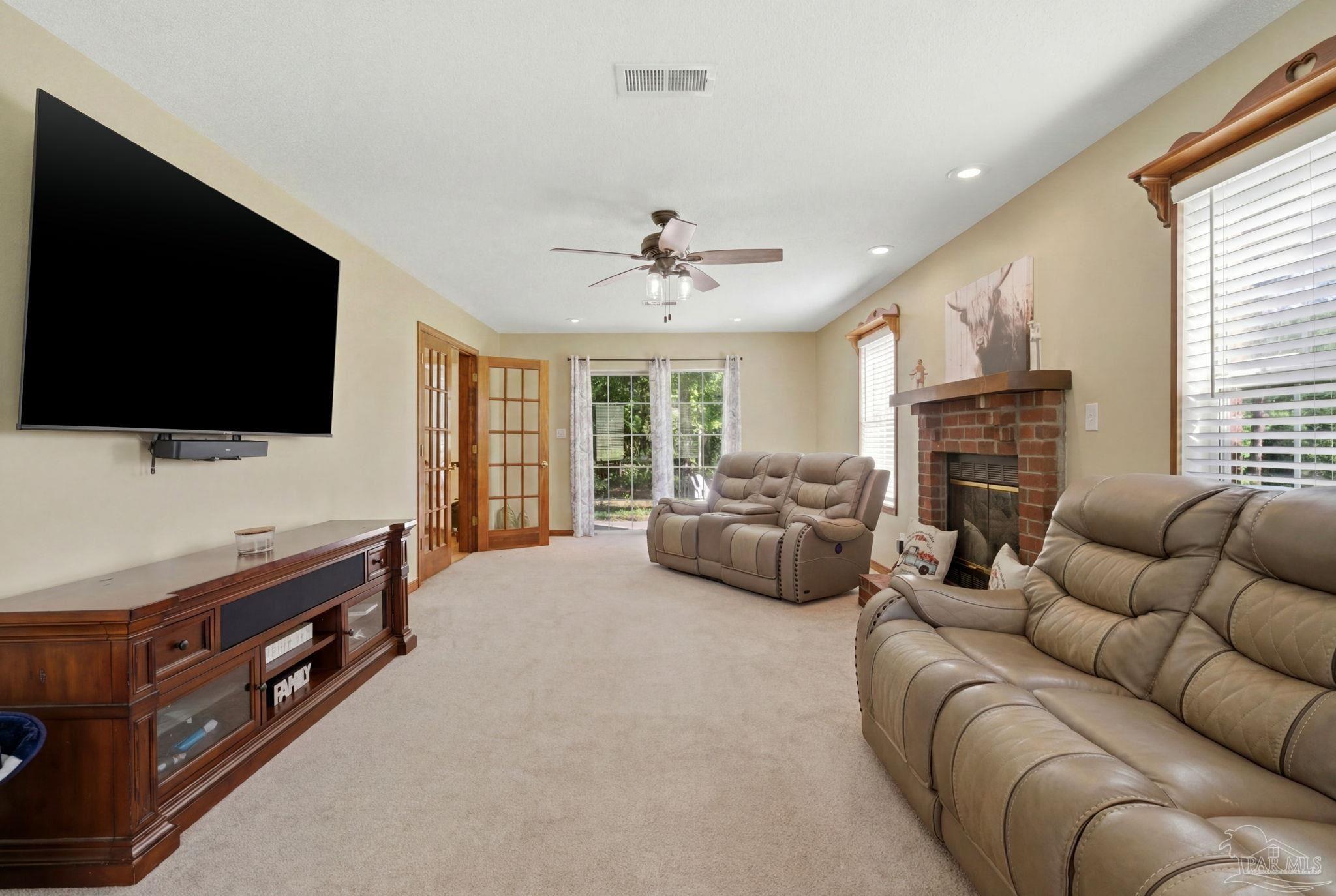 6870 Martin Road Milton, FL 32570 - Photo 16 of 48 a living room with furniture and a flat screen tv