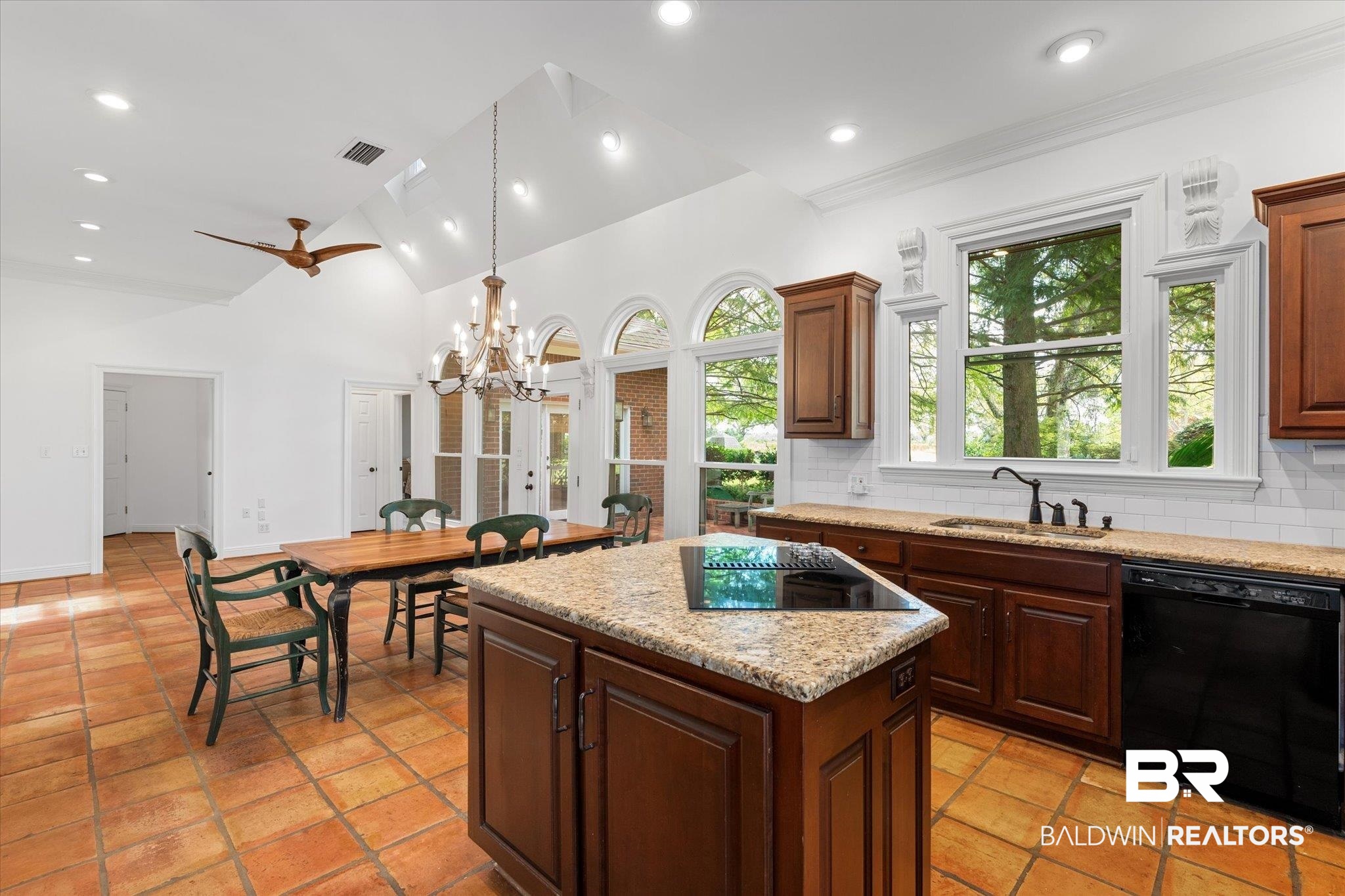 5231 Dawes Road Grand Bay, AL 36541 - Photo 13 of 49 Kitchen with sink, black appliances, a center island, ceiling fan with notable chandelier, and decorative backsplash
