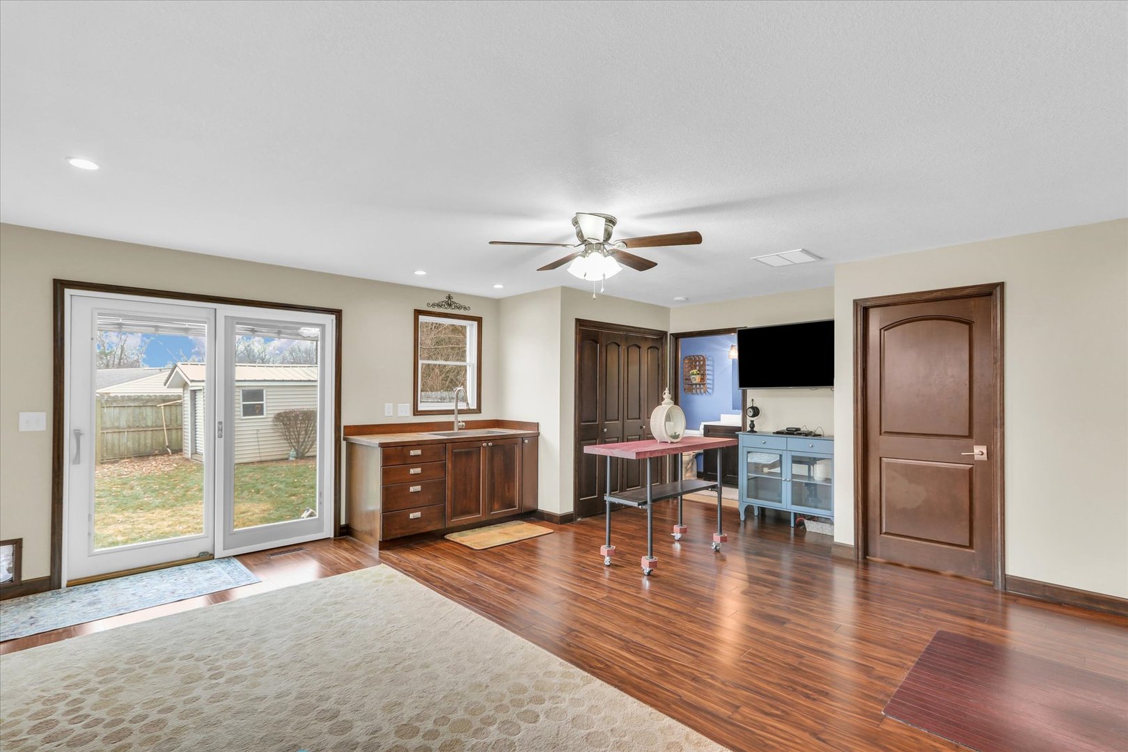703 East Washington Street Tolono, IL 61880 - Photo 18 of 38 a living room with furniture and a flat screen tv with wooden floor
