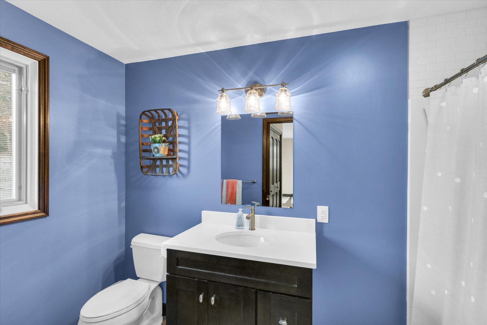 703 East Washington Street Tolono, IL 61880 - Photo 21 of 38 a bathroom with a sink vanity and a mirror