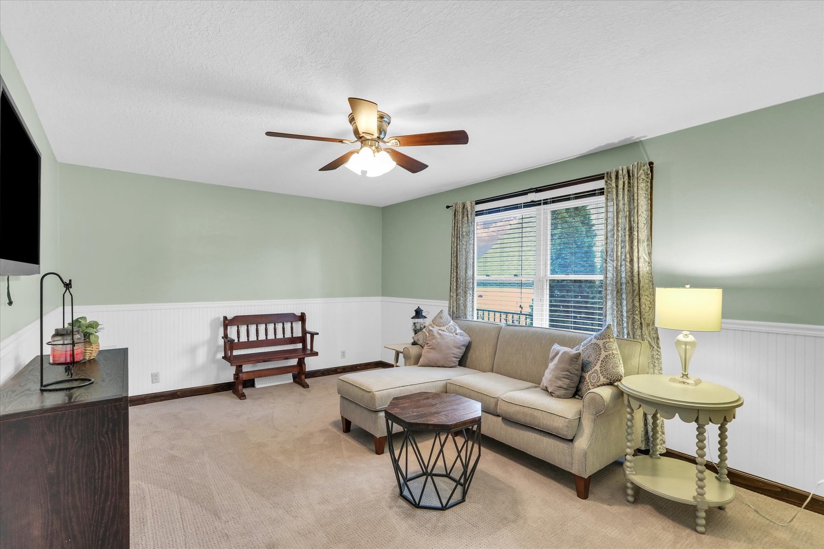 703 East Washington Street Tolono, IL 61880 - Photo 23 of 38 a living room with furniture a lamp and a flat screen tv
