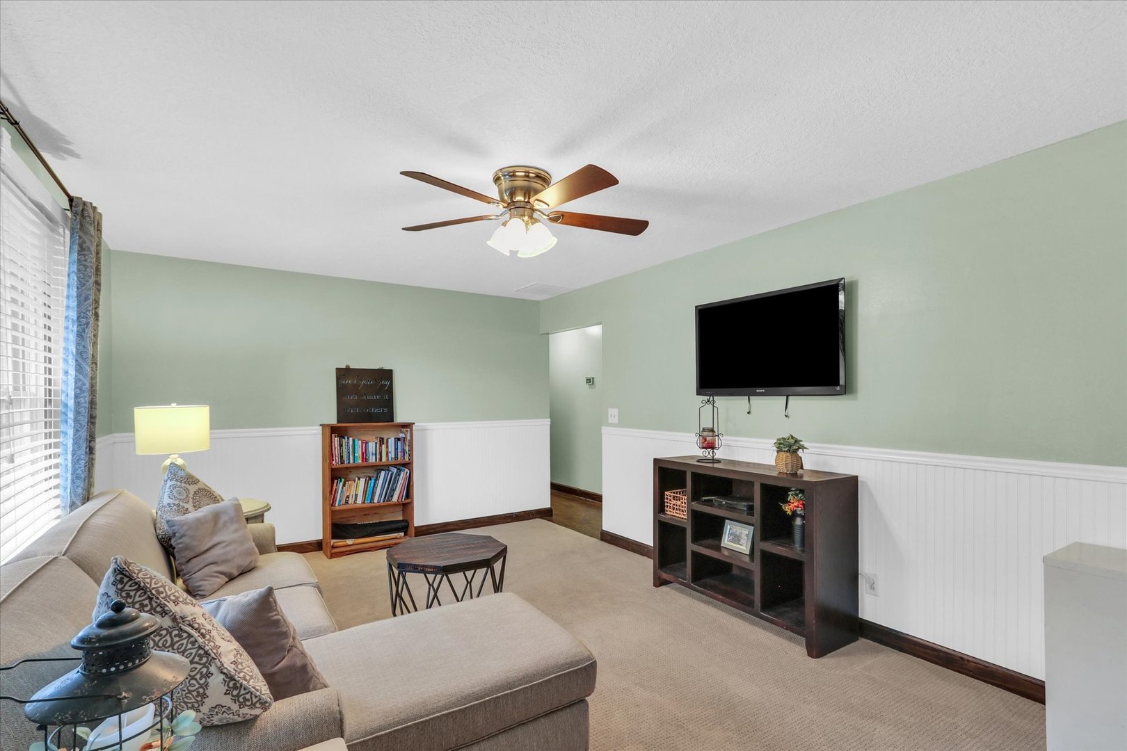 703 East Washington Street Tolono, IL 61880 - Photo 24 of 38 a living room with furniture and a flat screen tv