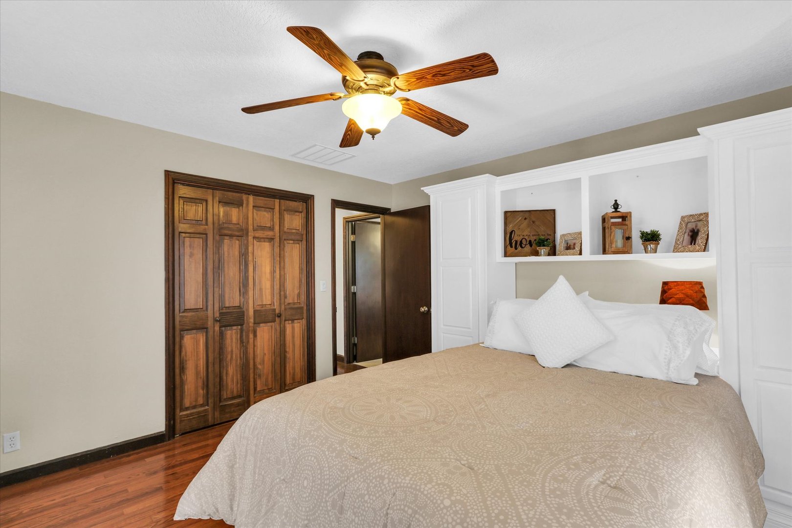 703 East Washington Street Tolono, IL 61880 - Photo 28 of 38 a bedroom with a large bed and a ceiling fan
