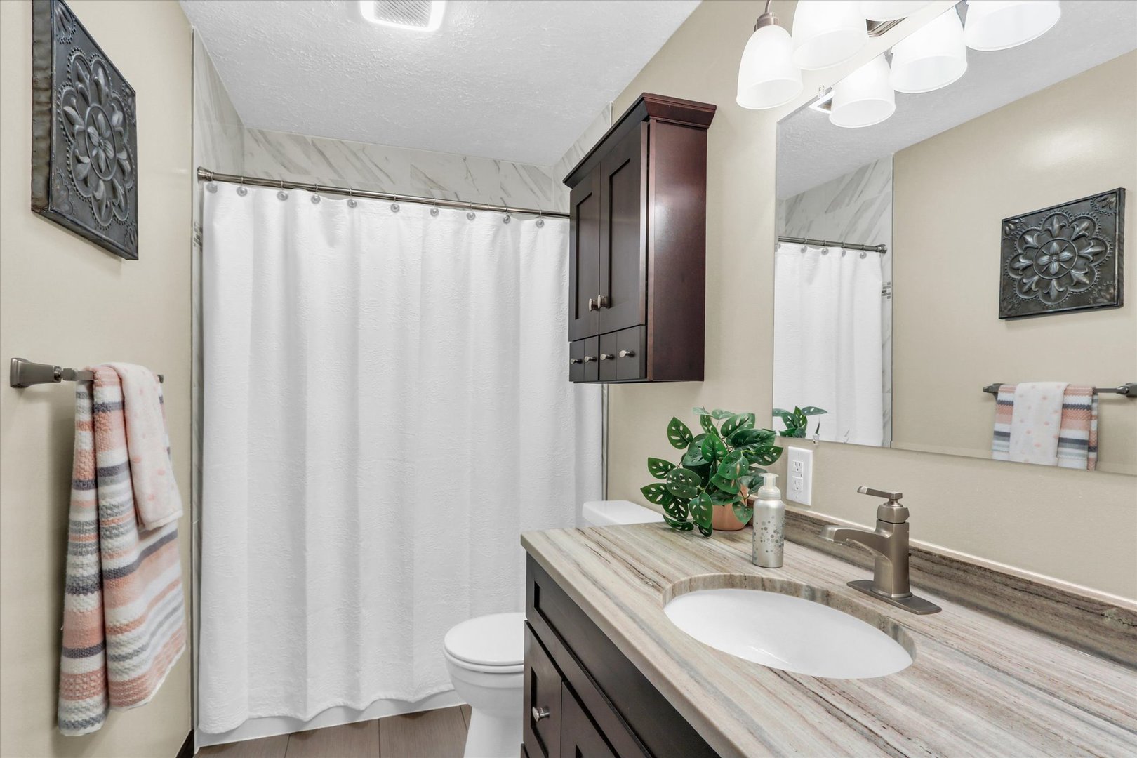 703 East Washington Street Tolono, IL 61880 - Photo 30 of 38 a bathroom with a granite countertop sink a toilet and a mirror