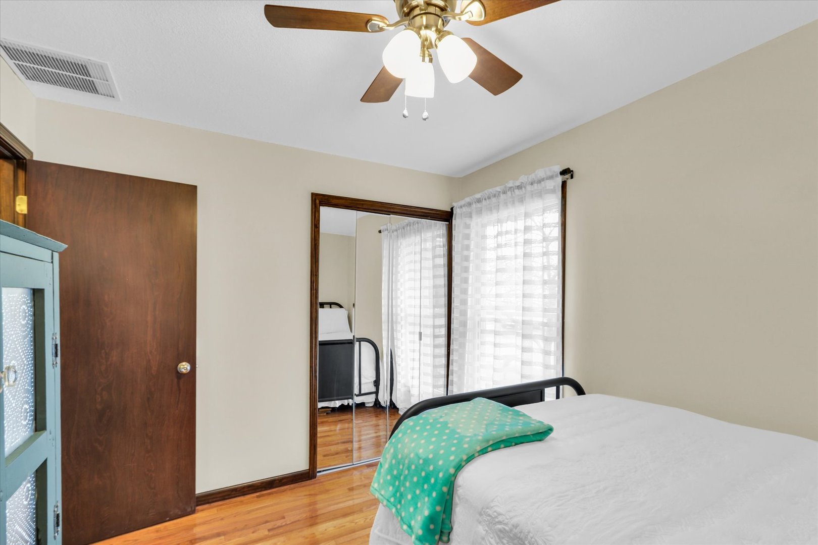 703 East Washington Street Tolono, IL 61880 - Photo 32 of 38 a bedroom with a bed and a chandelier