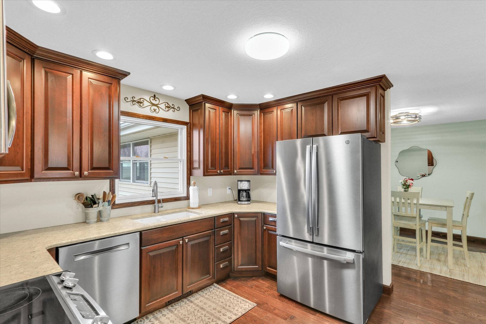 703 East Washington Street Tolono, IL 61880 - Photo 6 of 38 a kitchen with stainless steel appliances granite countertop a refrigerator and a sink