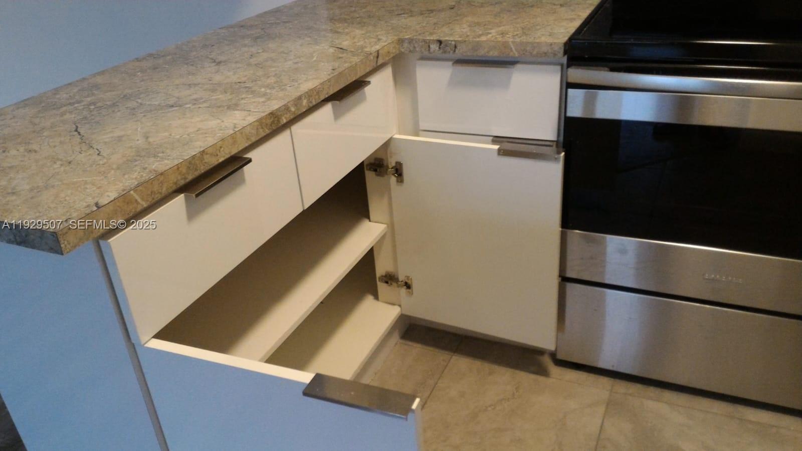 1755 Northeast 116th Road, Unit 15 North Miami, FL 33181 - Photo 3 of 9 a view of an empty kitchen