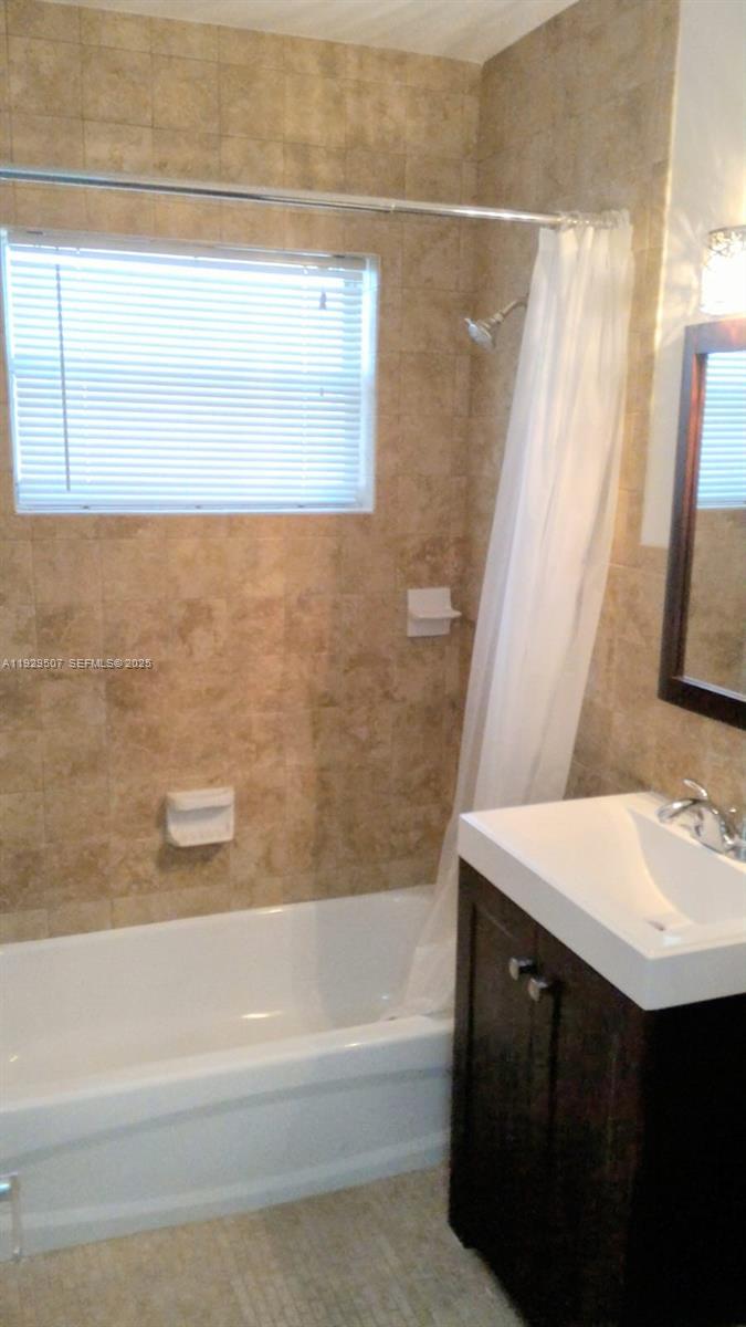 1755 Northeast 116th Road, Unit 15 North Miami, FL 33181 - Photo 6 of 9 a bathroom with a sink a bathtub and a shower