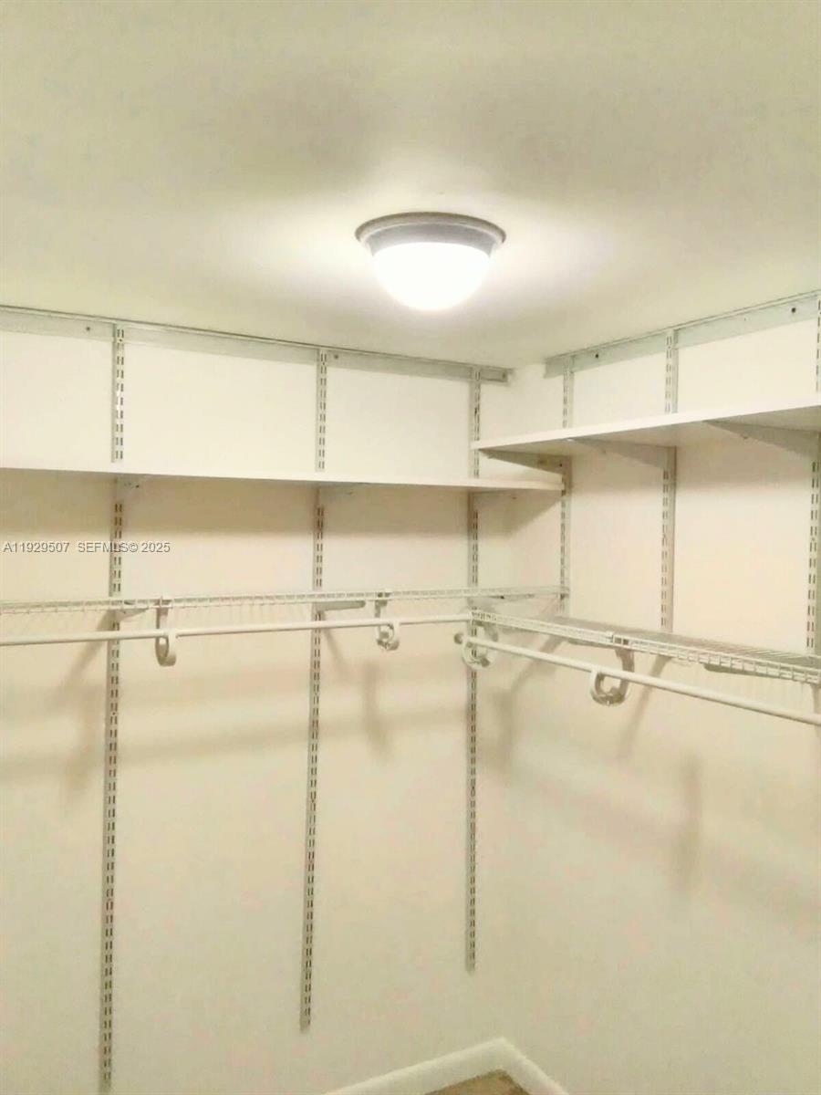 1755 Northeast 116th Road, Unit 15 North Miami, FL 33181 - Photo 8 of 9 a view of a walk in closet