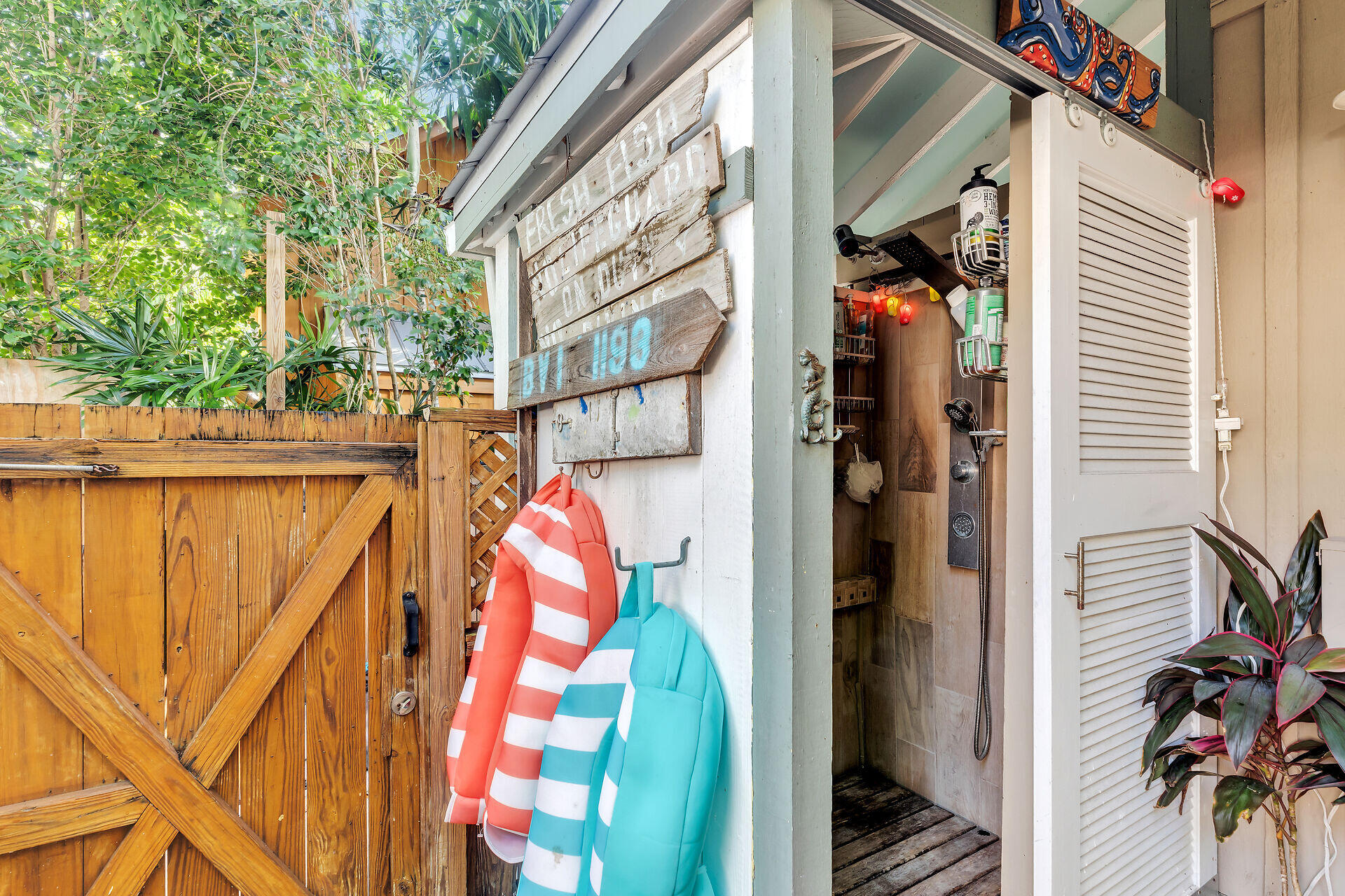 808 Virginia Street, Unit 4 Key West, FL 33040 - Photo 17 of 32 a view of walk in closet with clothes and plants