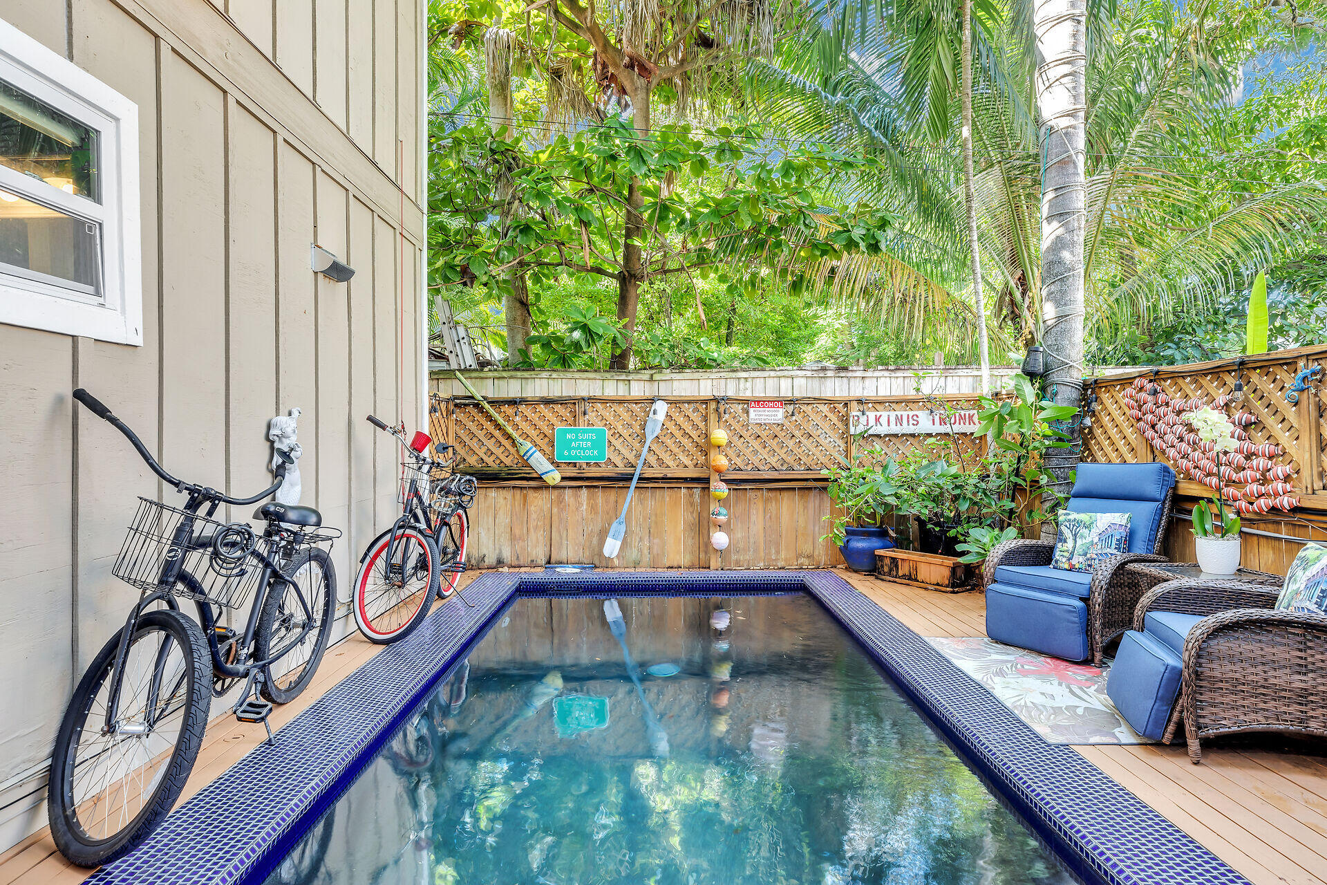 808 Virginia Street, Unit 4 Key West, FL 33040 - Photo 3 of 32 a balcony with wooden floor and furniture