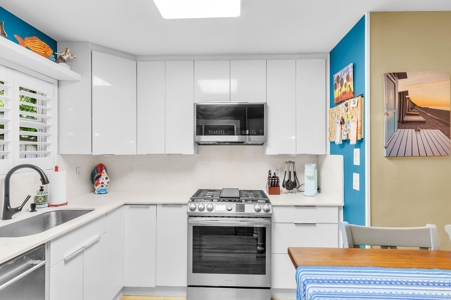 808 Virginia Street, Unit 4 Key West, FL 33040 - Photo 10 of 32 a kitchen with stainless steel appliances a stove microwave and sink