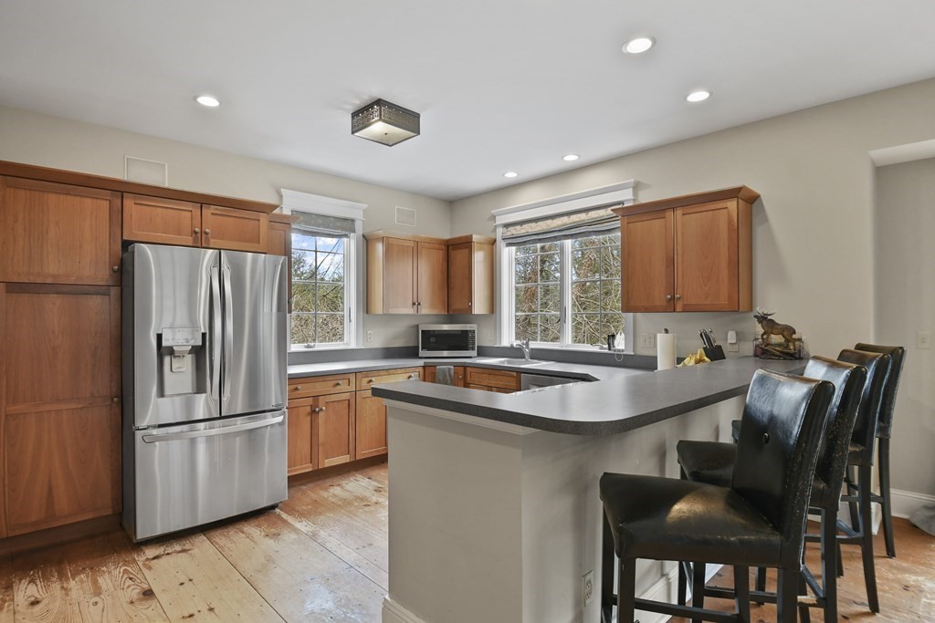 277 Secret Lake Road Athol, MA 01331 - Photo 16 of 36 a kitchen with granite countertop a sink and refrigerator