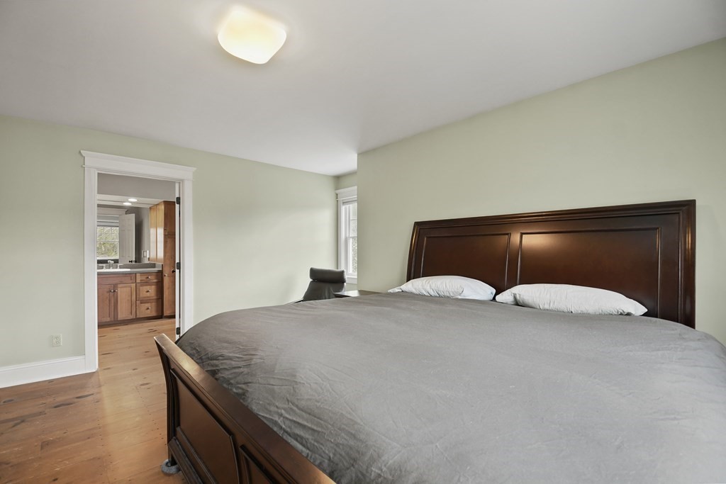 277 Secret Lake Road Athol, MA 01331 - Photo 22 of 36 a bedroom with a bed and a potted plant