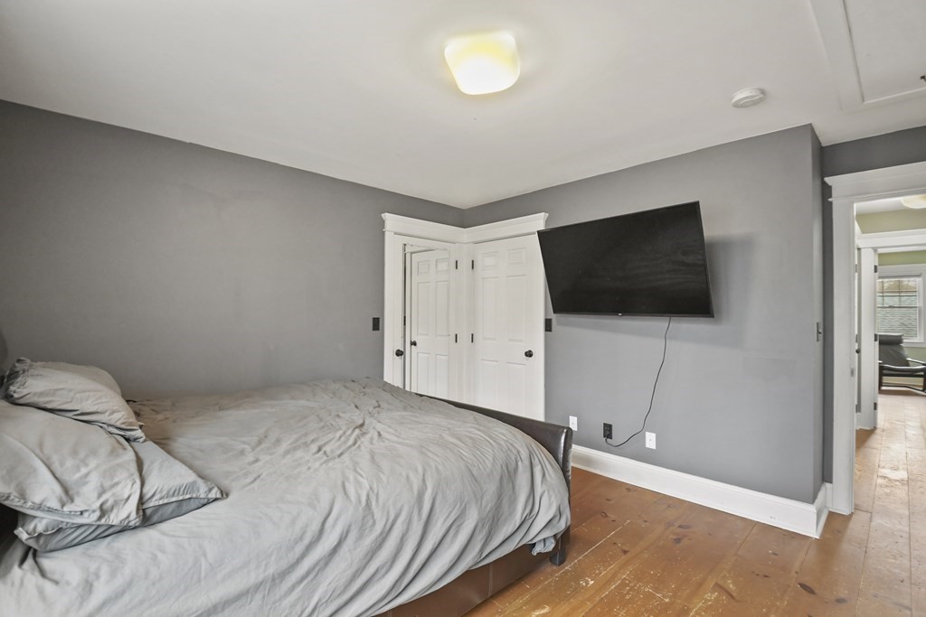 277 Secret Lake Road Athol, MA 01331 - Photo 26 of 36 a bedroom with a bed and a flat screen tv