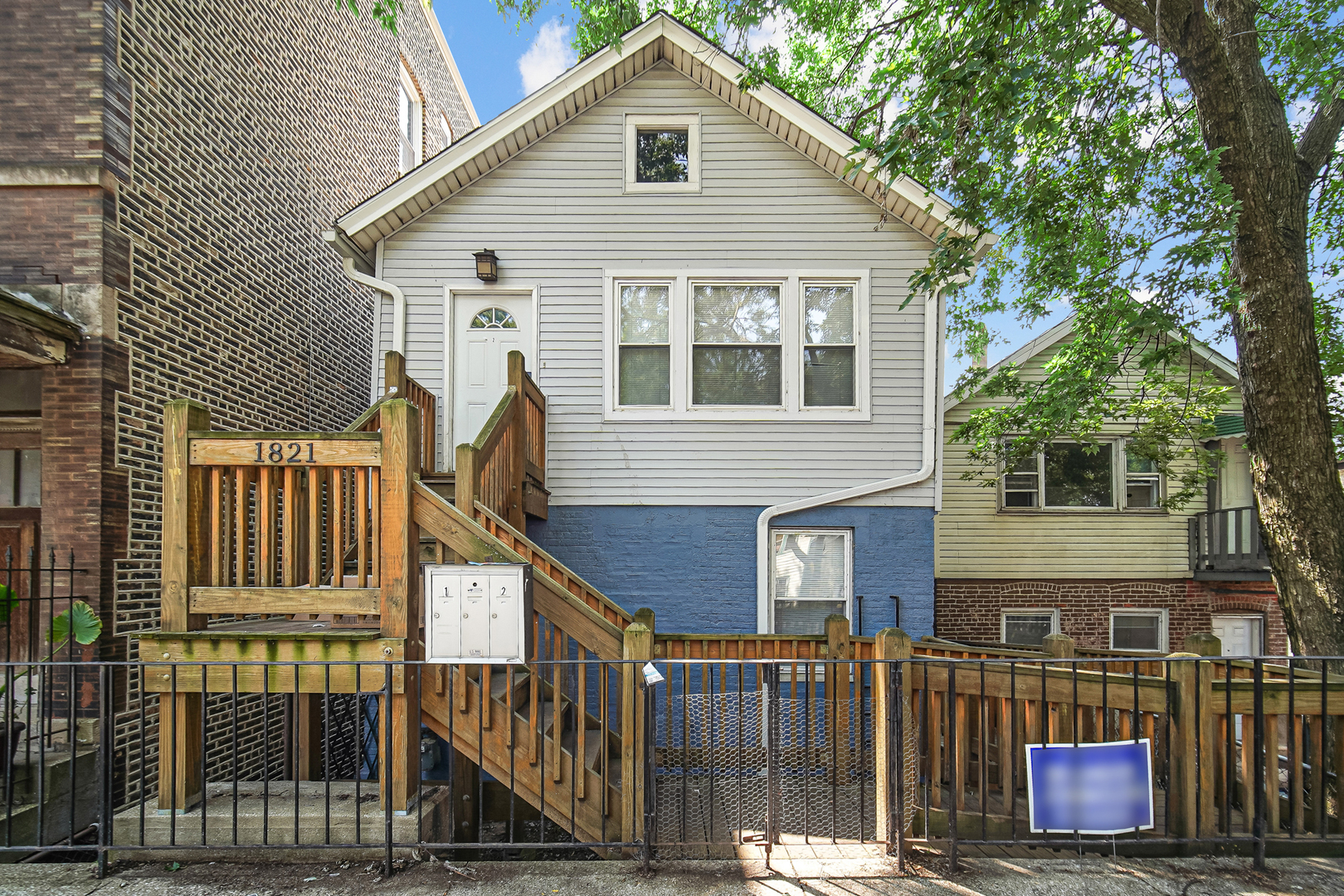 a view of a house with wooden fence and large windows