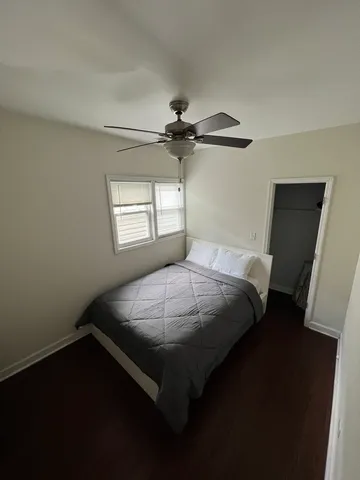a bed sitting in a bedroom next to a window