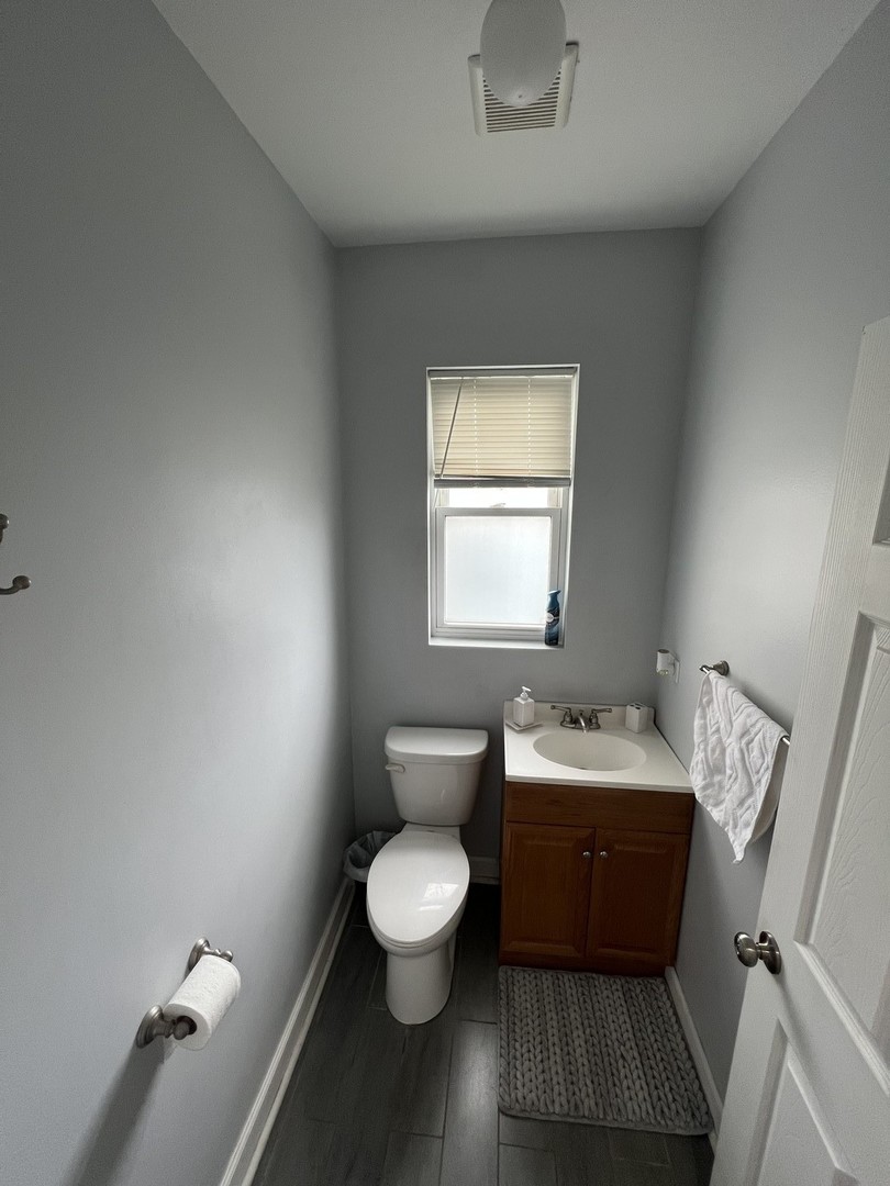 1821 West Cullerton Street, Unit 2 Chicago, IL 60608 - Photo 8 of 10 a bathroom with a toilet sink and mirror