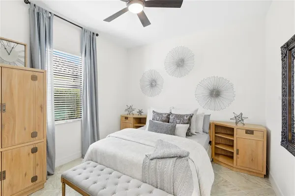 a bedroom with a bed and a window