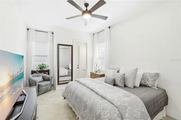 a bedroom with a balcony a bed and a chandelier